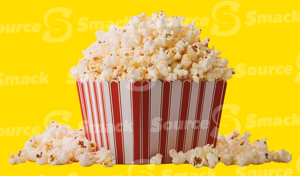 A popcorn box overflowing with popcorn clipped as a transparent image