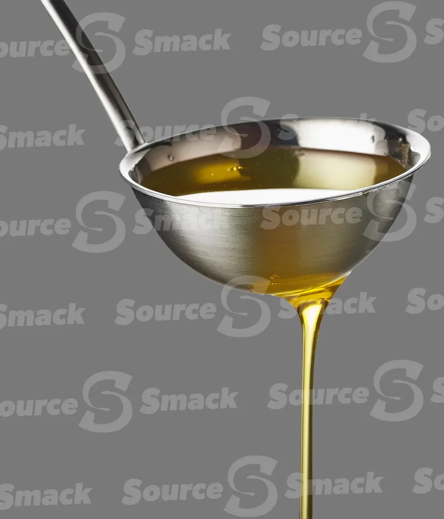 A ladle pouring oil clipped as a transparent image