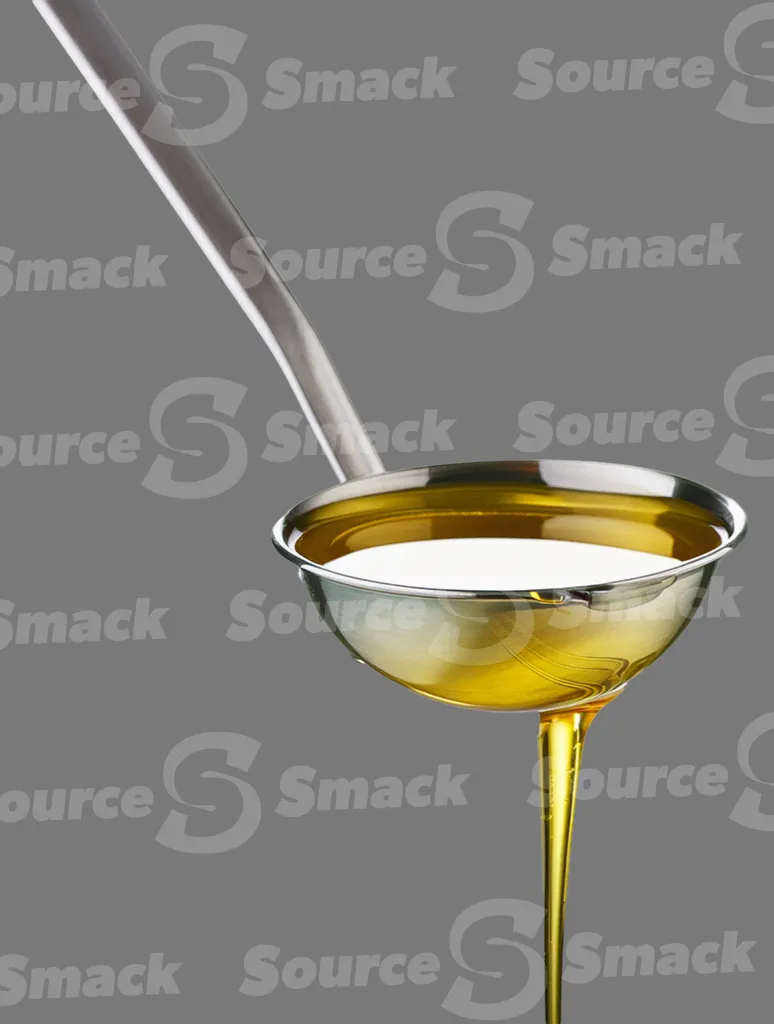 A ladle pouring oil clipped as a transparent image