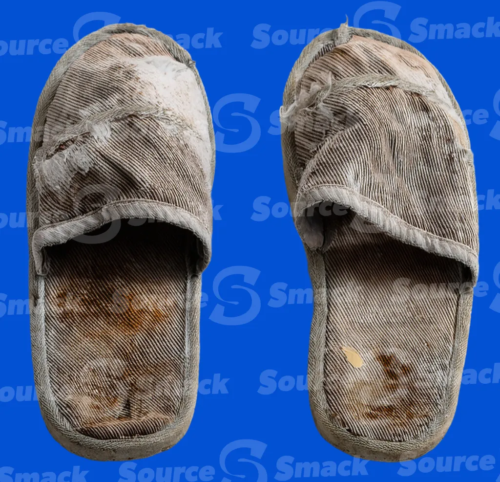 A worn and dirty discarded slipper clipped as a transparent image