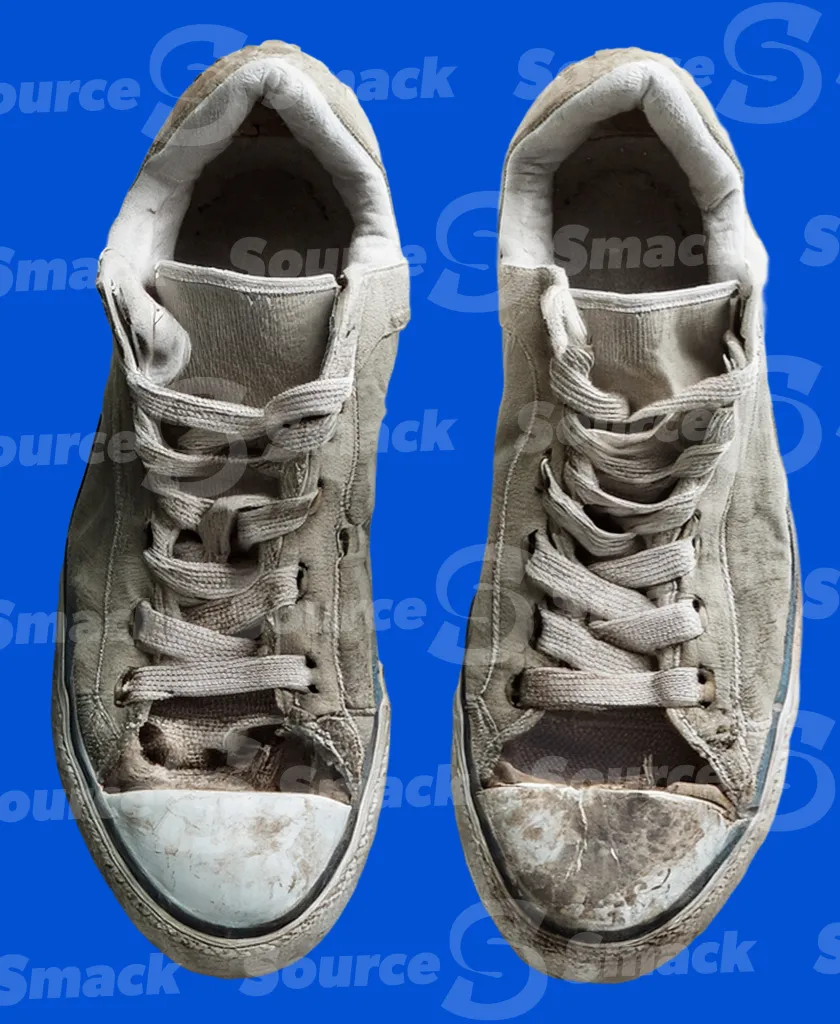 A pair of dirty and discarded sneakers clipped as a transparent image