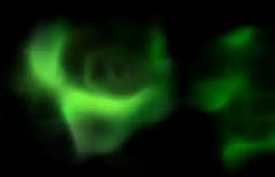 An atmospheric green gas floating in darkness