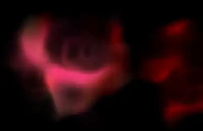 An atmospheric red gas floating in darkness