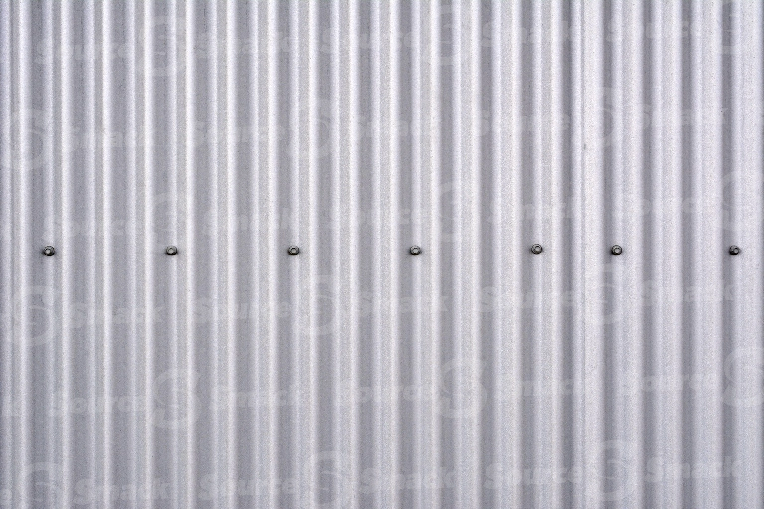 Ribbed metal wall with rivets