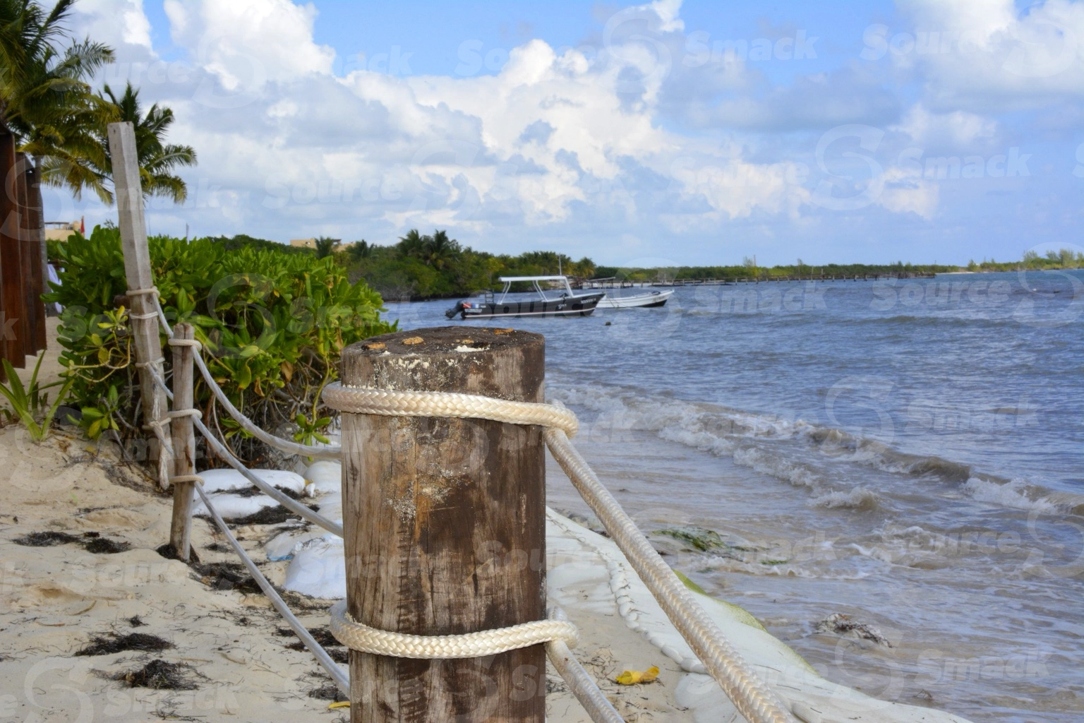 Roped off beach with boats in water at Blue Bay Resort in Mexico